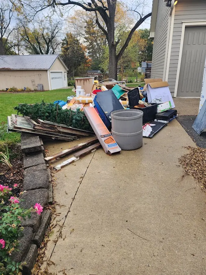 Dumpster being loaded with debris for Estate Cleanout Dumpster Rental in Weaver